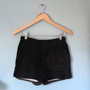 helena quinn suede leather shorts. black with striped lining, stretchy waistband